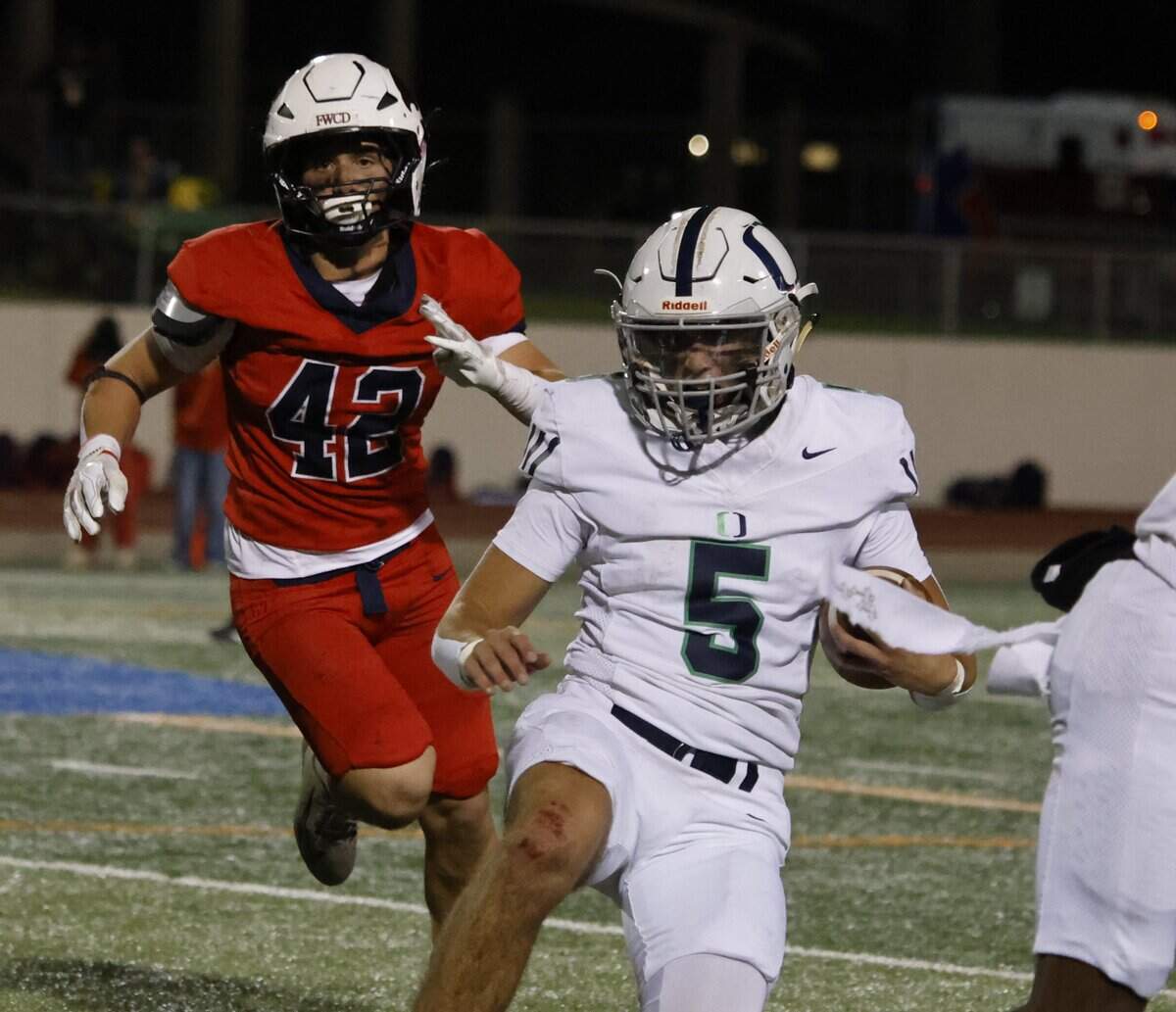 Oakridge quarterback Luke Dearman (5) slides down in bounds to burn time off the clock during the second half of the SPC 2025 3A Football Championship football game between The Oakridge School and Fort Worth Country Day at Mavericks Stadium in Arlington, Texas, Saturday Nov. 08, 2025.