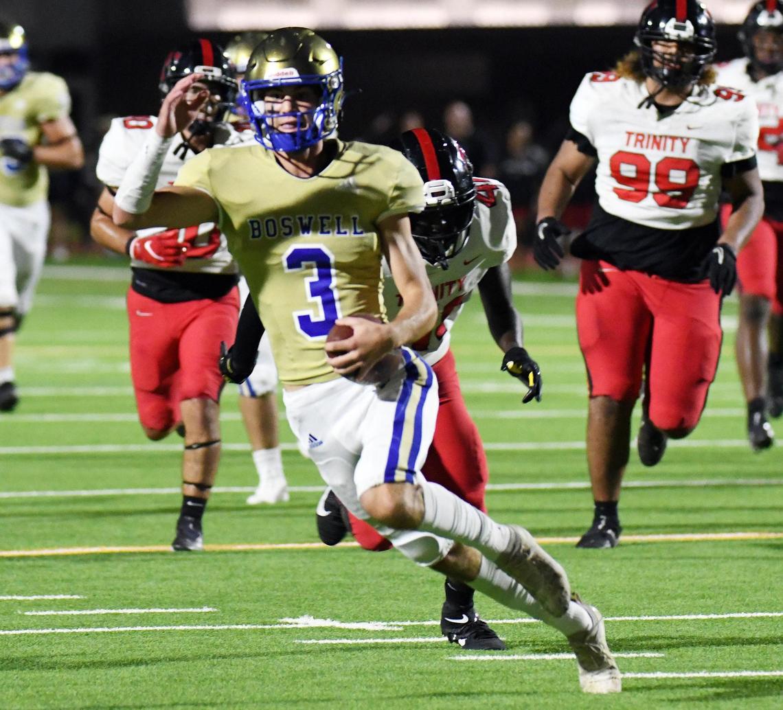 Boswell quarterback Sawyer Farr, front scrambles out of the backfield 28 yards against Trinity for the touchdown to take a 14-13 lead in the first quarter of Friday’s September 16, 2022 District 3-6A football game at Boswell High School Pioneer Stadium in Fort Worth, Texas. Special/Bob Haynes