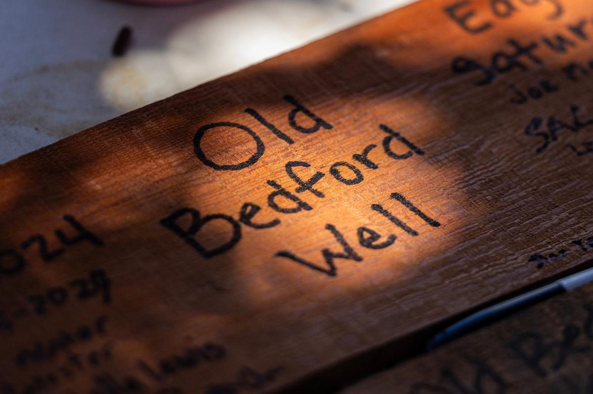 One of the wood panels with the signatures from everyone working on the Bedford well restoration project in Bedford.