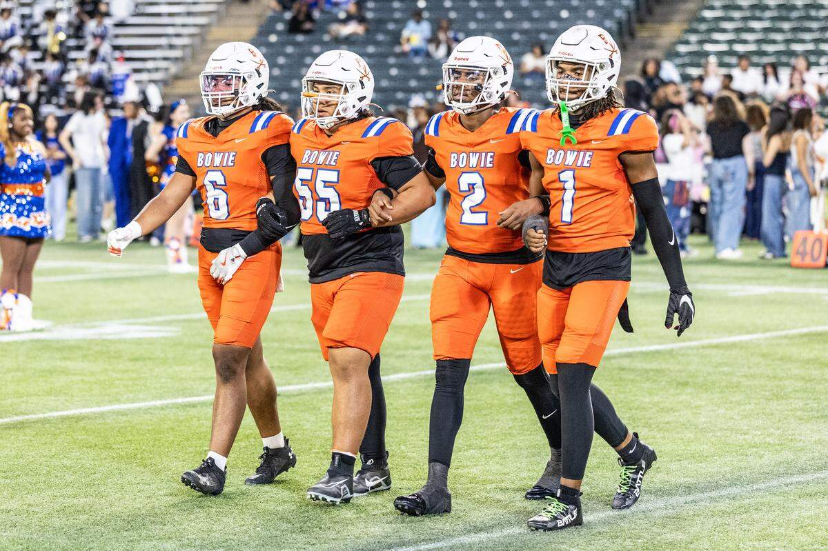 The Arlington Bowie captains walk to the coin toss before the game against Haltom on Thursday, Oct. 23, 2025, at Choctaw Stadium in Arlington.