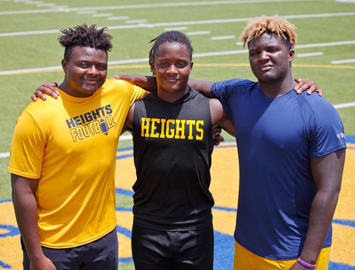 Arlington Heights Yellow Jacket players and head coach Curtis James sons, defensive end Carter, running back Carson and defensive end Caynan and running back Carson at the schools football field in Fort Worth, Texas, Thursday July 17, 2025.