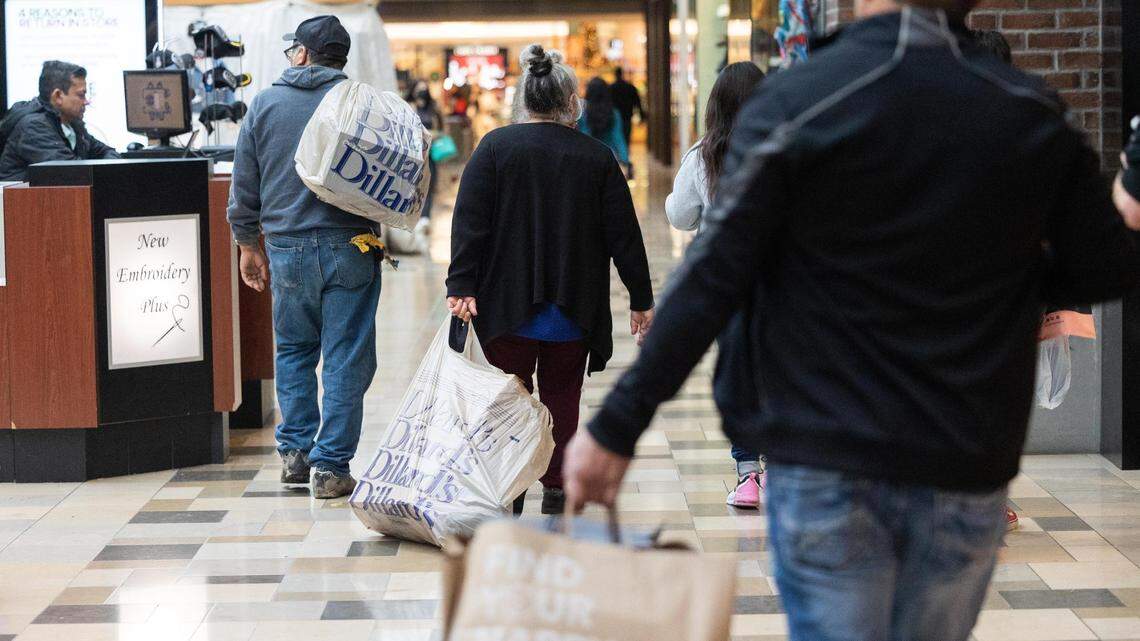 Shoppers carries varies bags between stores on Black Friday, Nov. 25, 2022, at North East Mall in Hurst.