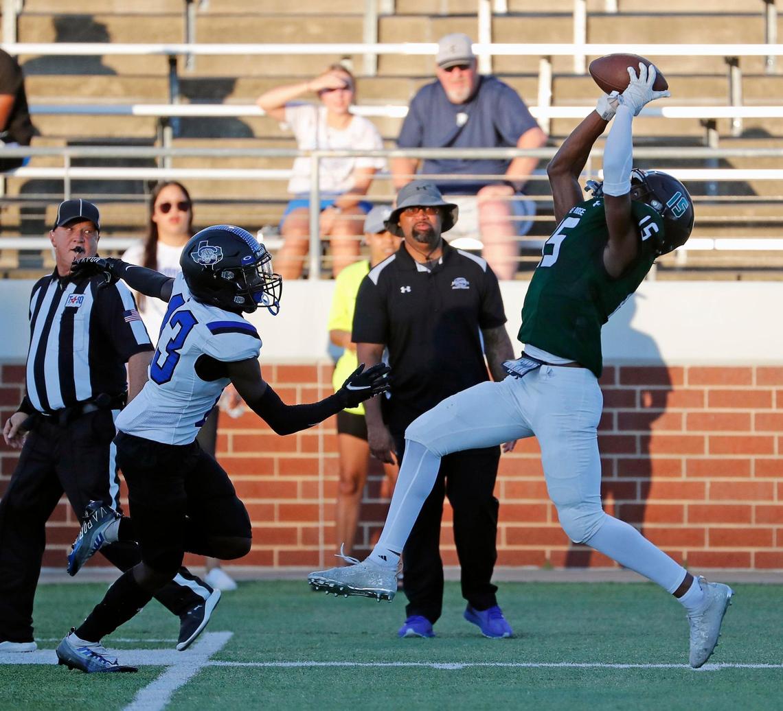 Lake Ridge wide receiver Zaden Jackson catches a pass over the head of Summit defensive back Michael Oladimeji (13).
