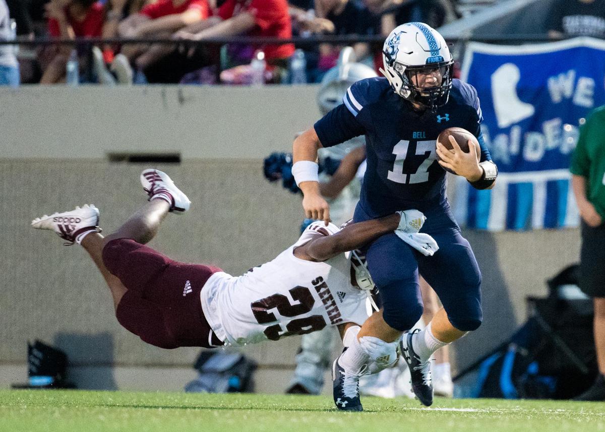 Mesquite quarterback Landry Choate (17) keeps the ball, running up the field before Ira Carter (29) reaches out to help with the tackle at Pennington Stadium on Sep. 19 2019.