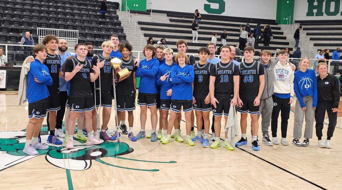 The Decatur Eagles pose with the trophy after winning against Fort Worth Eastern Hills in a Class 4A Division 1 bi-district game on Monday, February 17, 2025 at Azle High School. Decatur won 65-63 in overtime.