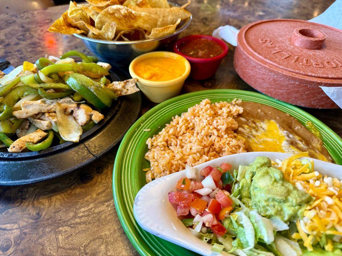 A chicken fajitas platter, left, with sides, chips and tortillas at Campo Verde restaurant in Dalworthington Gardens Oct. 15, 2024.