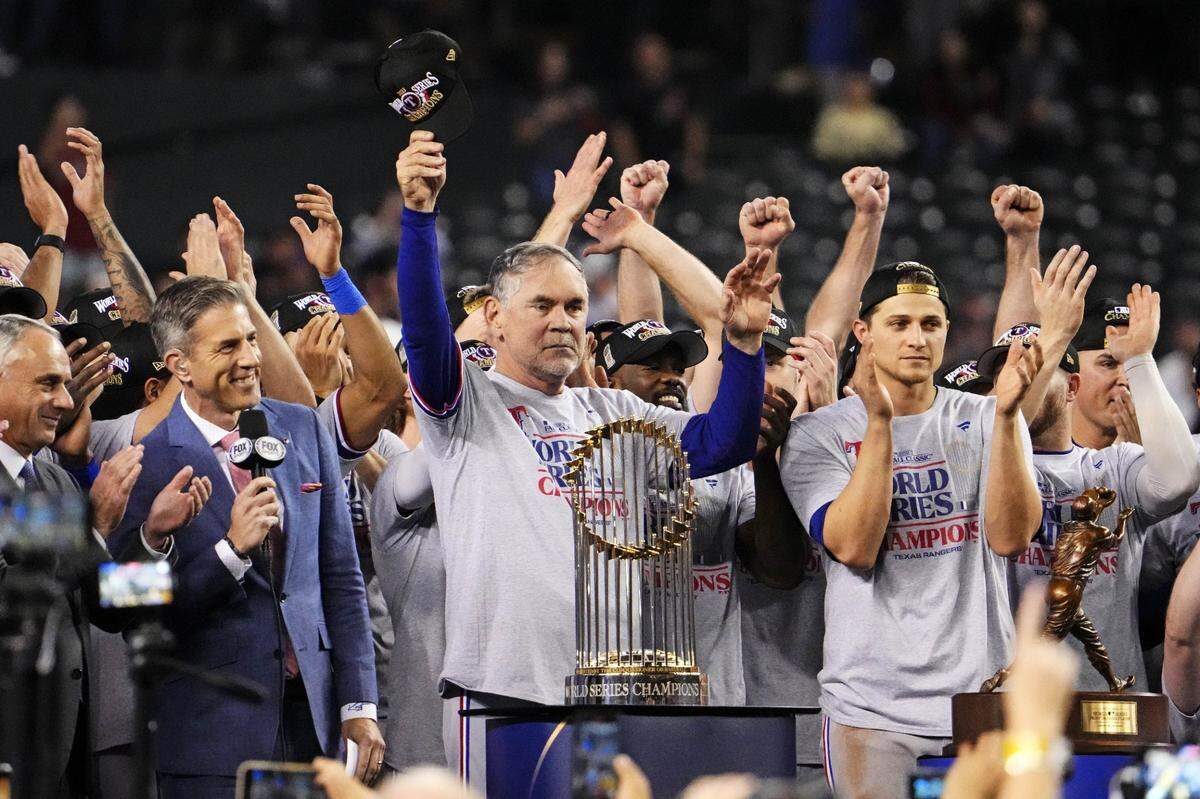 Texas Rangers manager Bruce Bochy celebrates with the Commissioners Trophy after the Rangers beat the Arizona Diamondbacks in game five of the 2023 World Series on Nov. 1 at Chase Field in Phoenix.