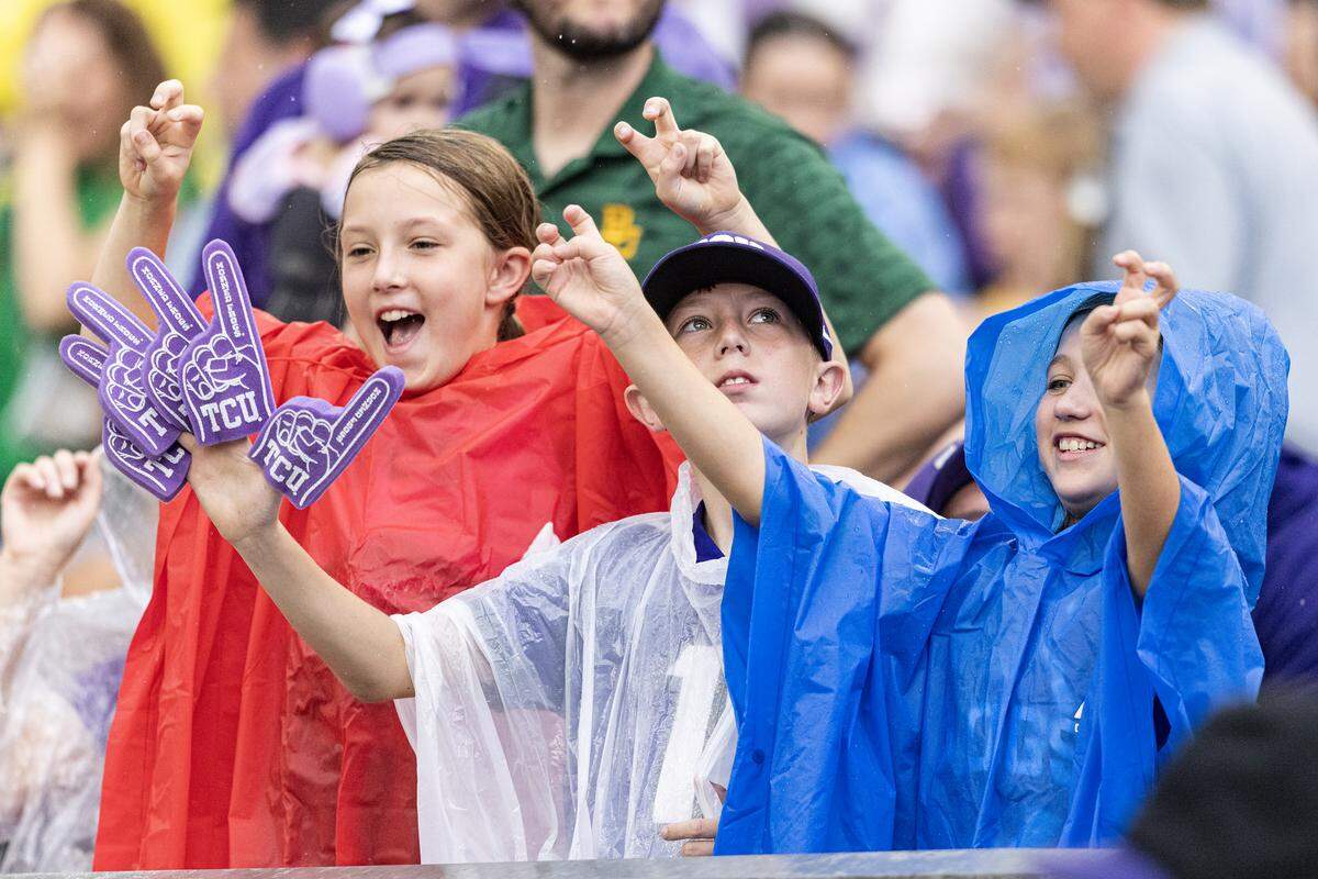 Young TCU fans celebrate during a first down in the first half of a Big XII football game between the TCU Horned Frogs and the Baylor Bears at Amon G Carter Stadium in Fort Worth on Saturday, Oct. 18, 2025.