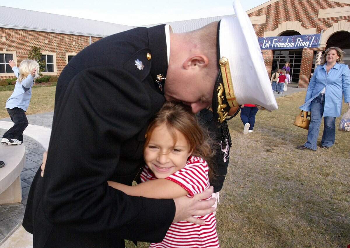 Nov. 11, 2005: Lt. Col. Matthew Hundley hugs his 6-year-old daughter Rachel after a Veterans Day celebration at Freedom Elementary School in Keller.
