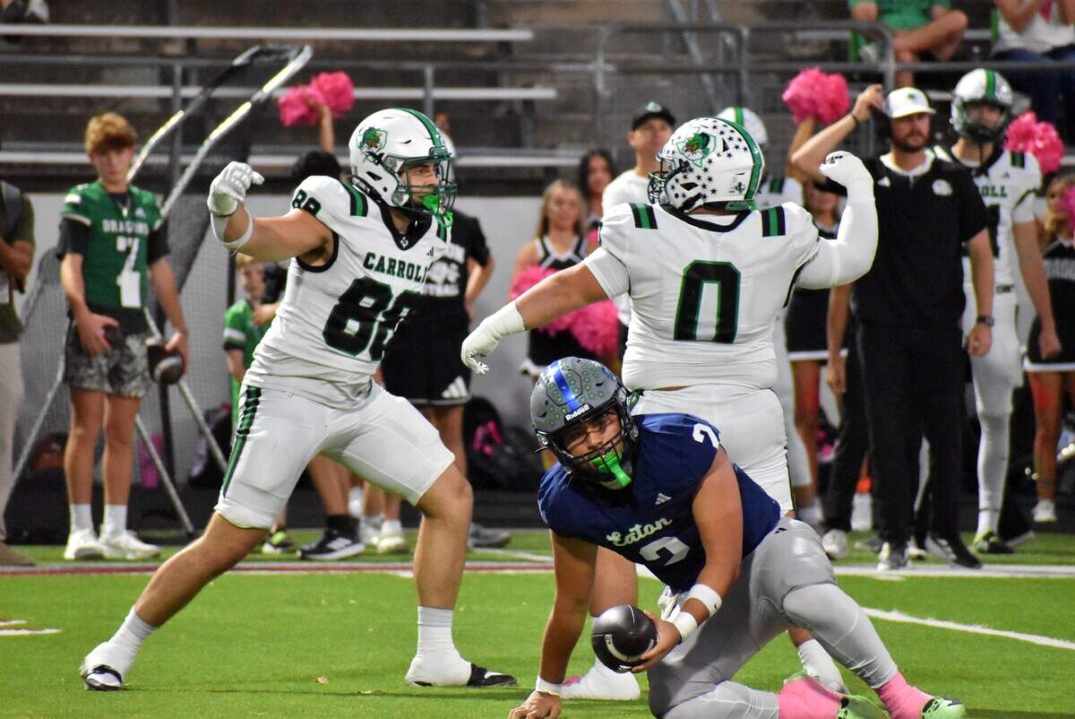 Southlake Carroll’s Crawford Taylor (88) and Jake Lucky (0) celebrate after sacking Haslet V.R. Eaton quarterback Kalika Nisa in the second quarter of a UIL football Class 6A game against Haslet V.R. Eaton at Northwest ISD Stadium in Justin on Thursday, Oct. 9, 2025.