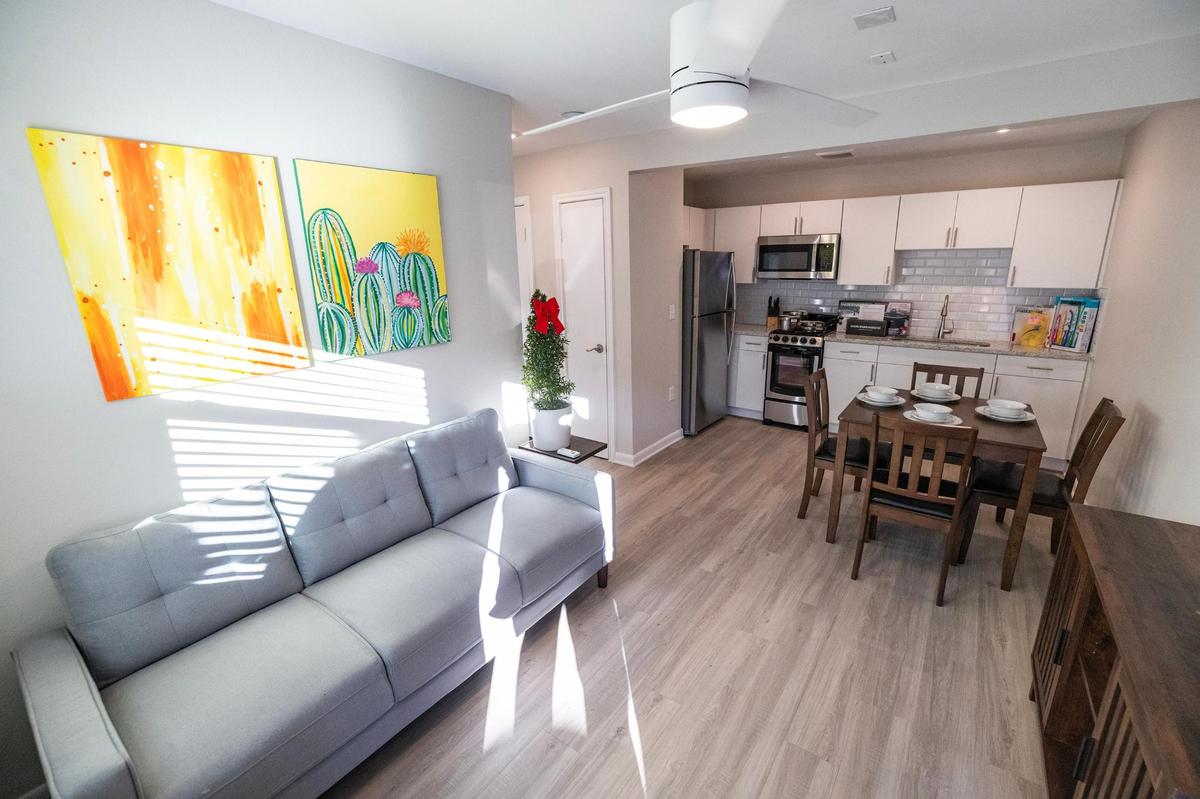 The living room and kitchen inside a model two-bedroom unit at the Casa de los Sueños apartments in Fort Worth. Units in the new complex designed to help families experiencing homelessness are fully equipped.
