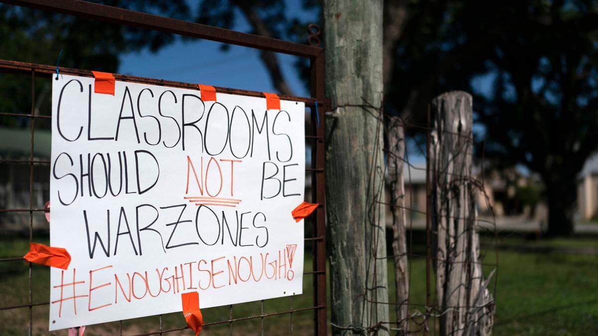 A sign asking for a change hangs on a fence near Robb Elementary School in Uvalde, Texas, Friday, June 3, 2022. Tarrant County police and school officials joined Texas House Democrats during a town hall Thursday addressing gun safety.