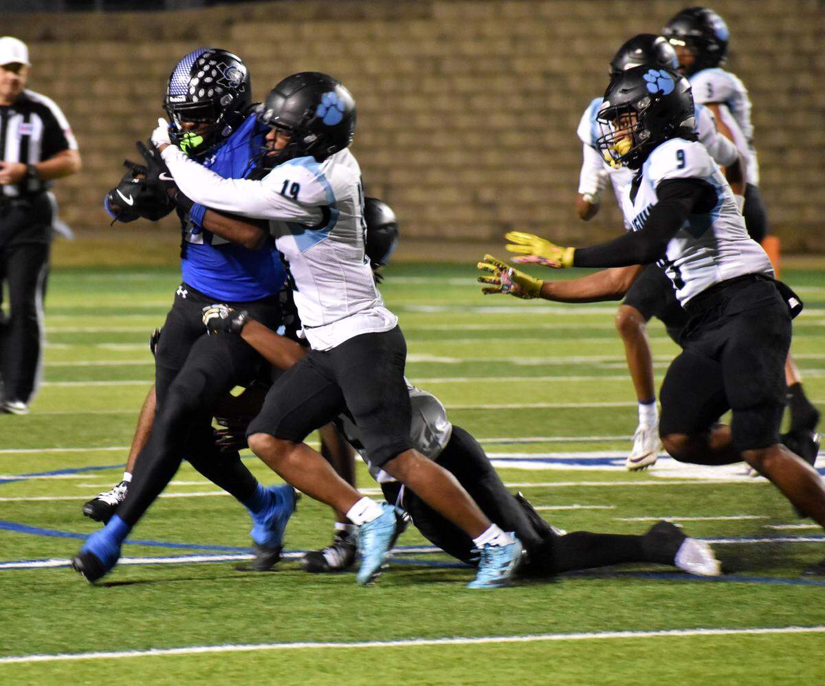 Arlington Seguin Preston Randall (19) tackles Mansfield Summit’s Omogbolaha Daudu during the second quarter of a Class 5A game at Vernon Newsom Stadium on Thursday, Nov. 6, 2025.