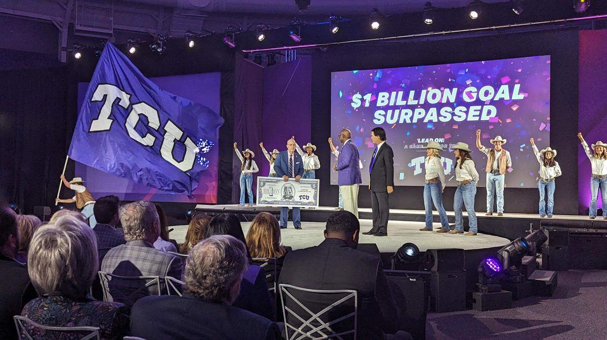 A stage with people from TCU celebrating raising over $1 billion. 