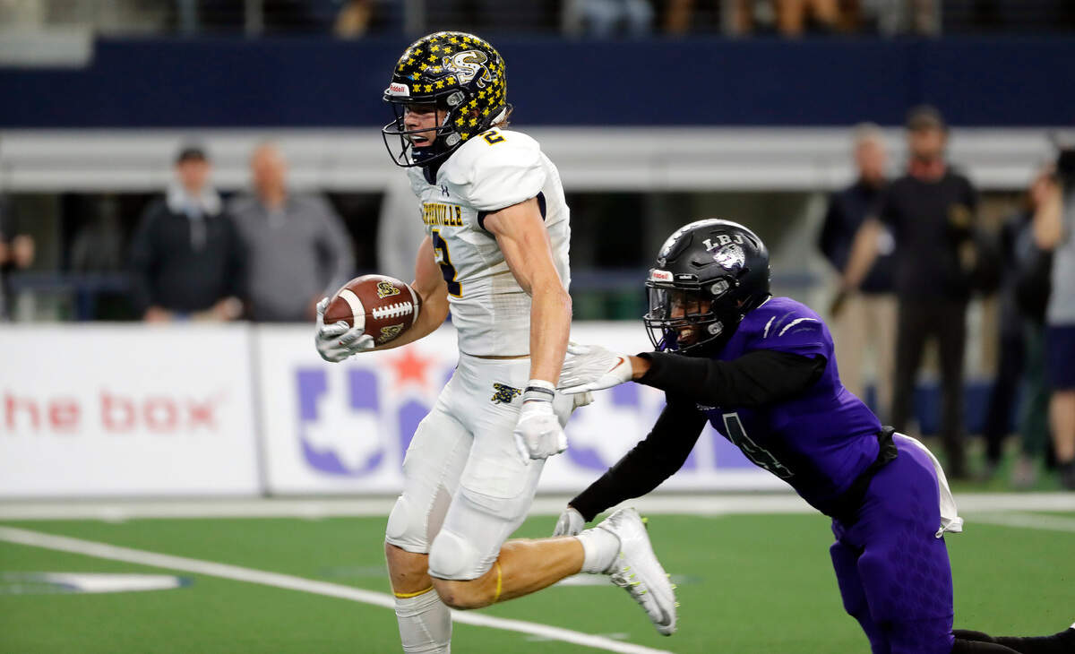 Stephenville wide receiver Coy Eakin (2) shakes off Austin LBJ defensive back Jaybreon Riggins (4) to score during a high school 4A division 1 state championship football game at AT&T Stadium in Arlington, Texas, Friday, Dec. 17, 2021. Stephenville defeated Austin LBJ 38-21. (Special to the Star-Telegram Bob Booth)