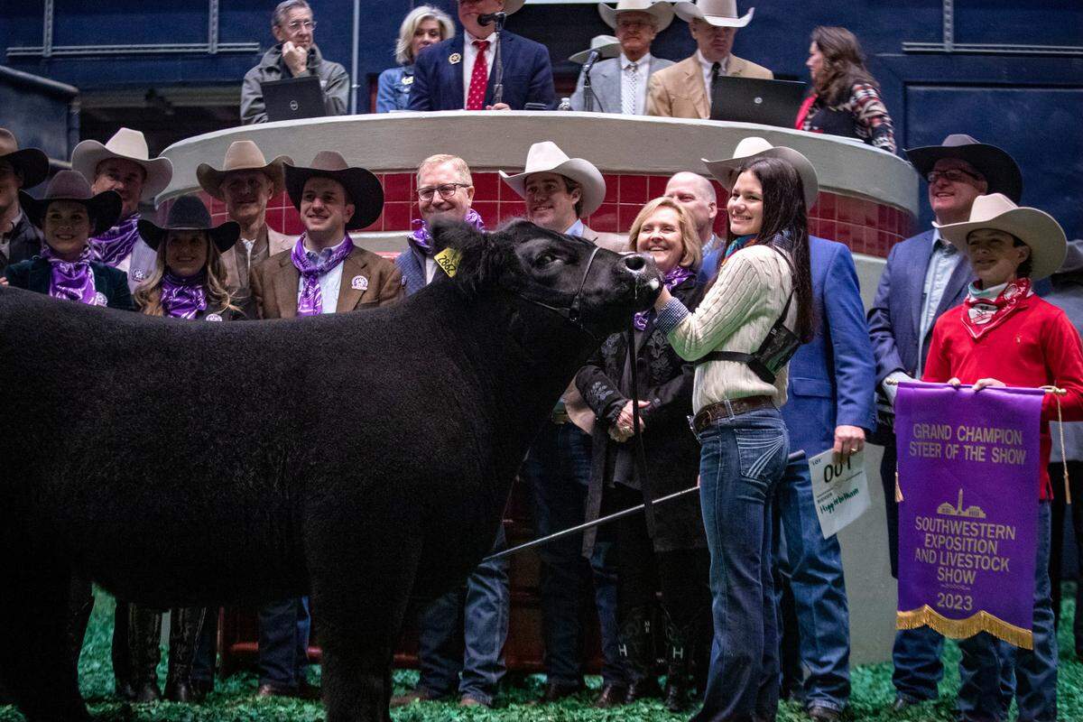 Sadie Wampler stands with buyers after her 2023 Grand Champion steer was auctioned during the Fort Worth Stock Show & Rodeo’s Junior Sale of Champions on Saturday, Feb. 4, 2023. Wampler’s steer was sold for $440,000, beating last year’s record by $130,000.