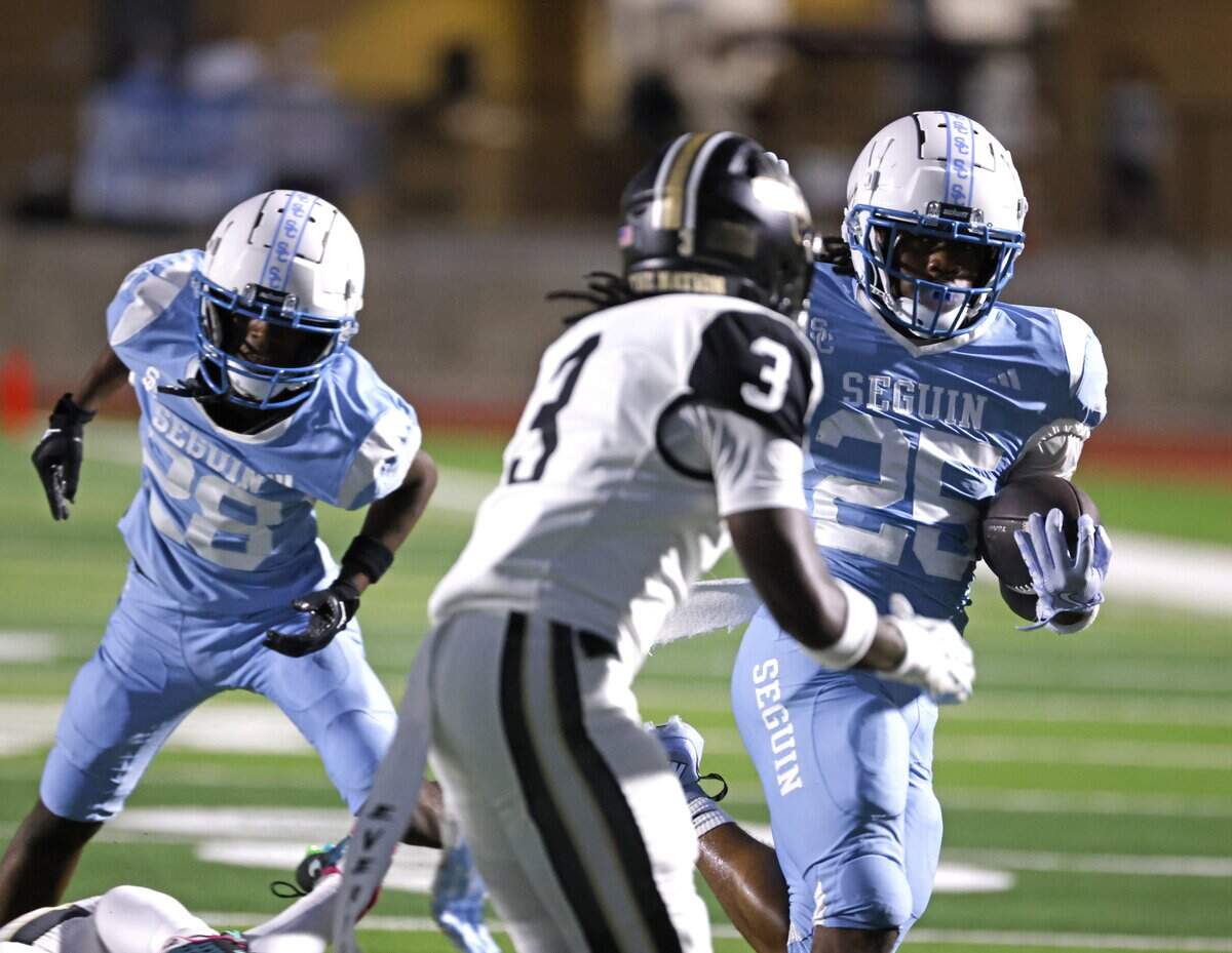 Arlington Seguin running back Ka’darrius Trotter (25) attempts to get away from The Colony defensive back Tre Burton (3) during the first half of a UIL football game between The Colony and Arlington Seguin at Glaspie Field in Arlington, Texas, Thursday, Sept. 25, 2025.
