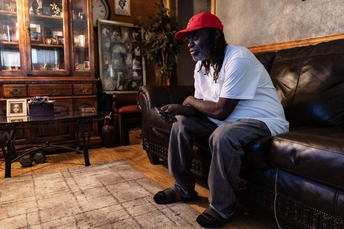 Scotti Choice sits on his couch and watches the television in his house in Fort Worth on Nov. 8, 2025. Ever since his mother died, Choice said he has been going through a deep depression and has no motivation to go outside.