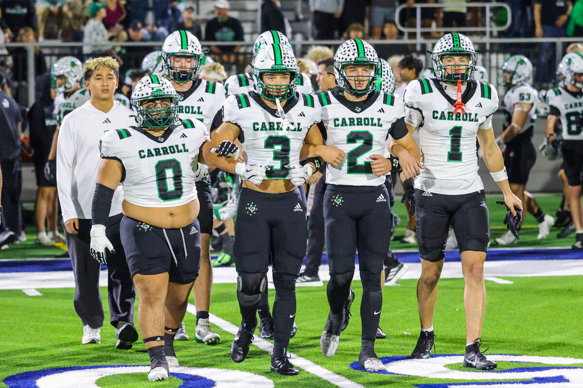 The Southlake Carroll captains walk onto the field before a Class 6A Division II area playoff game against San Angelo Central on Friday at Art Briles Stadium in Stephenville.