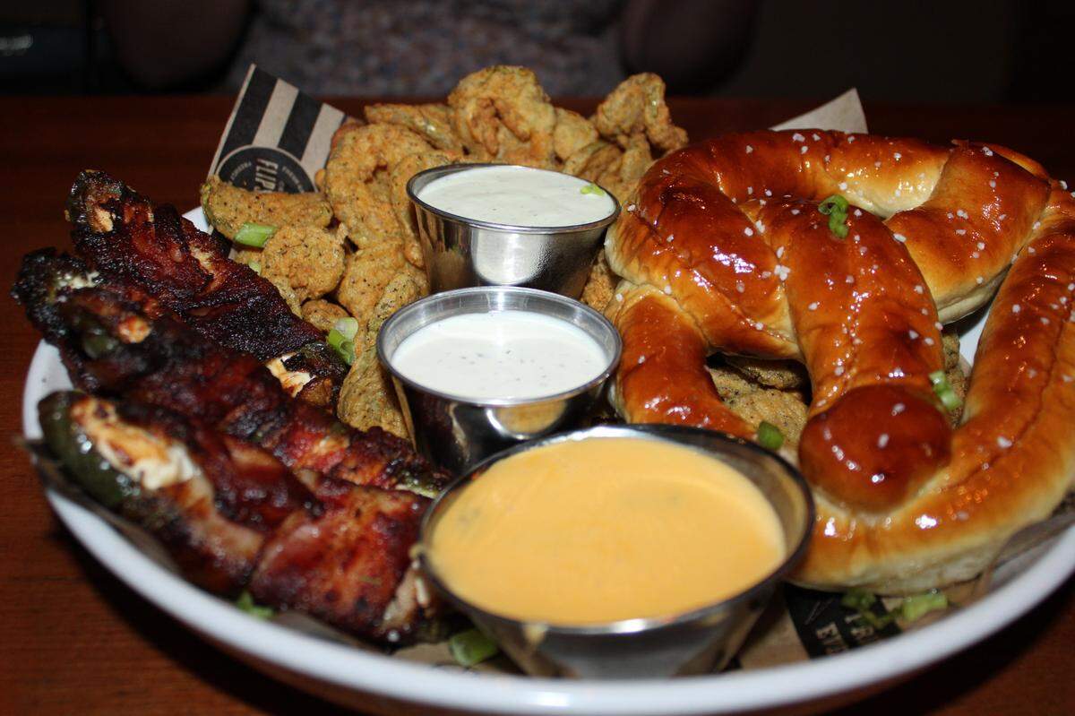 Flip’s appetizer sampler for $15 gets guests three appetizers of their choice in one platter. Pictured is the Fried Pickles, Salted Pretzel and Bacon Wrapped Jalapenos.