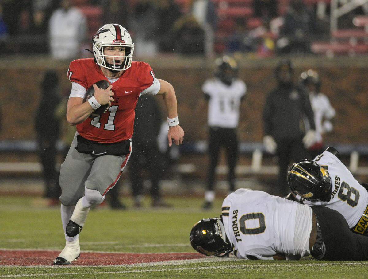 Argyle quarterback Maguire Gasperson (11) flees from South Oak Cliff defenders during a Class 5A Division II state semifinal on Friday, Dec. 13, 2024 at Gerald J. Ford Stadium in University Park, Texas.