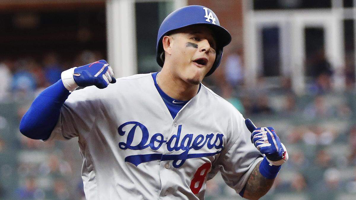 Los Angeles Dodgers’ Manny Machado (8) celebrates his three-run homer against the Atlanta Braves during the seventh inning in Game 4 of baseball’s National League Division Series, Monday, Oct. 8, 2018, in Atlanta. (AP Photo/John Bazemore)