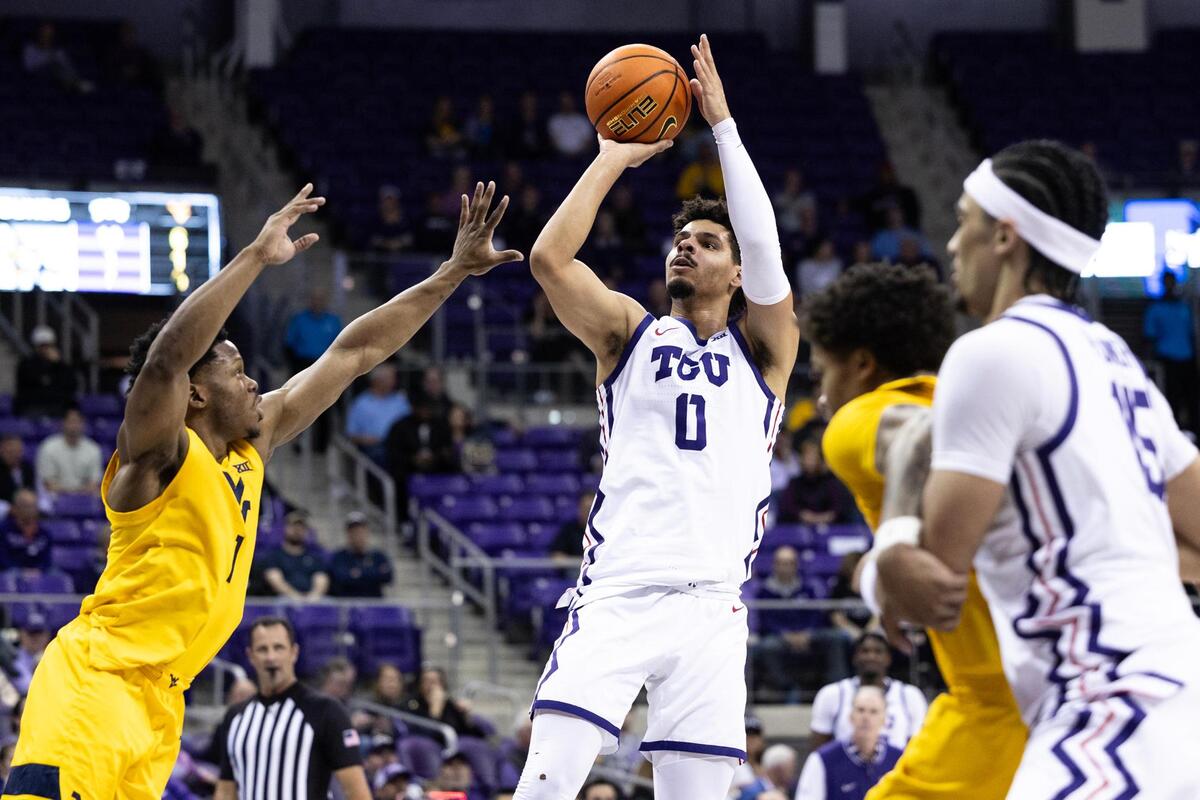 TCU forward Brendan Wenzel (0) shoots a shot over West Virginia guard Joseph Yesufu (1) in the first half of an NCAA game between TCU and West Virginia at Schollmaier Arena in Fort Worth on Wednesday, Feb. 5, 2025.