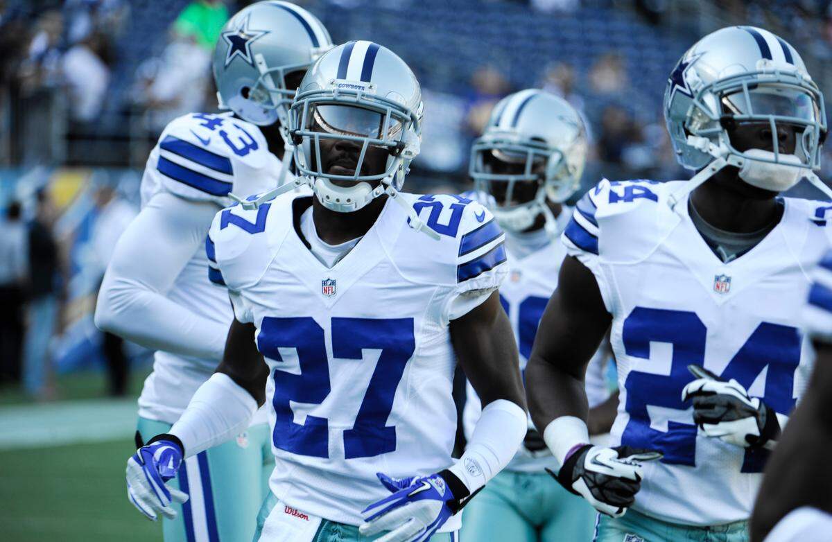 Former Dallas Cowboys defensive back C.J. Wilson (left) is the new head coach of Fort Worth Polytechnic High School. (AP Photo/Denis Poroy)