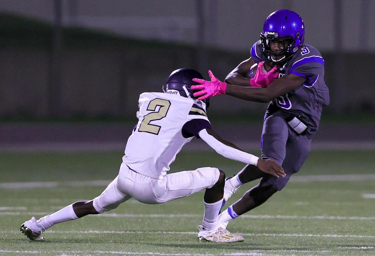 Dunbar wide receiver Aaryn Conley (3) tries to avoid being tackled by Dallas Life Oak Cliff defensive back James Farmer-Cole (2) during the first half; Friday night; September 11; 2020 played at Clark Stadium in Fort Worth; TX.; Steve Nurenberg/Special to the Star-Telegram