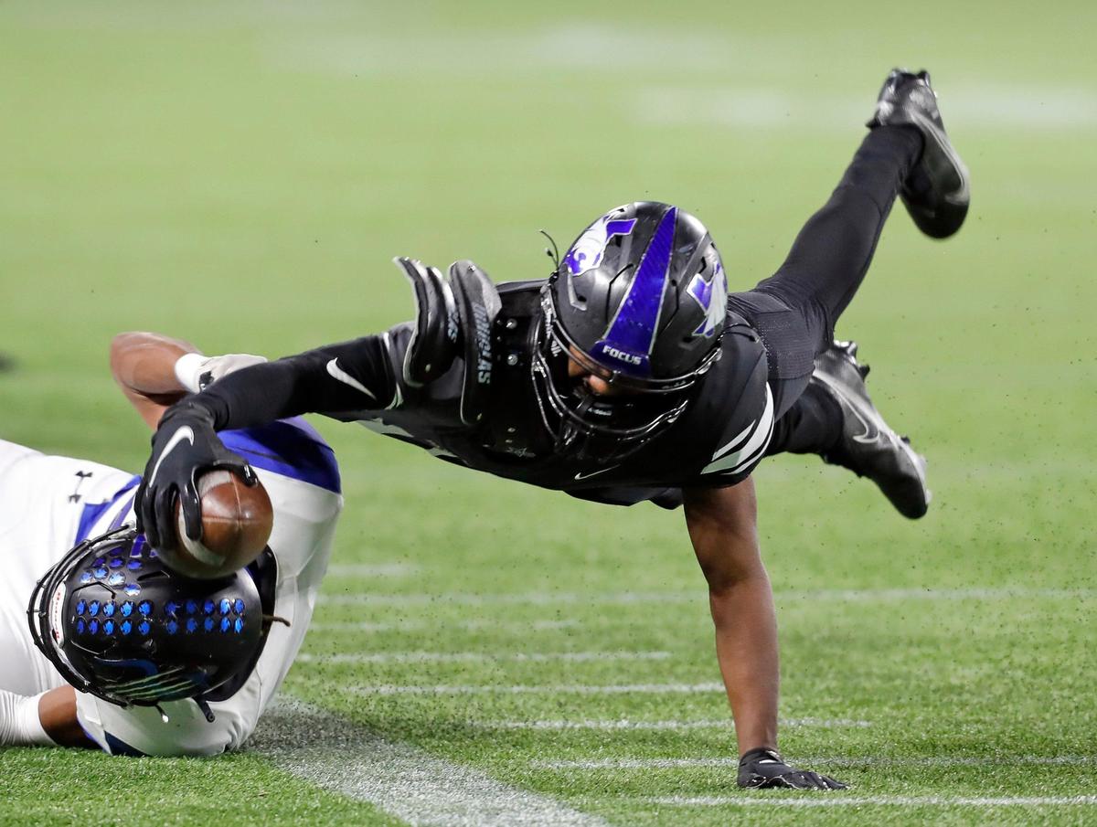 North Crowley quarterback Quinton Jackson (10) stretches to get the ball out of bounds to stop the clock with seconds remaining in the first half of a high school 6A Division 2 bi-district football playoff game at Globe Life Park in Arlington, Texas, Friday, Dec. 11, 2020. Byron Nelson led 7-3 at the half. (Special to the Star-Telegram Bob Booth)