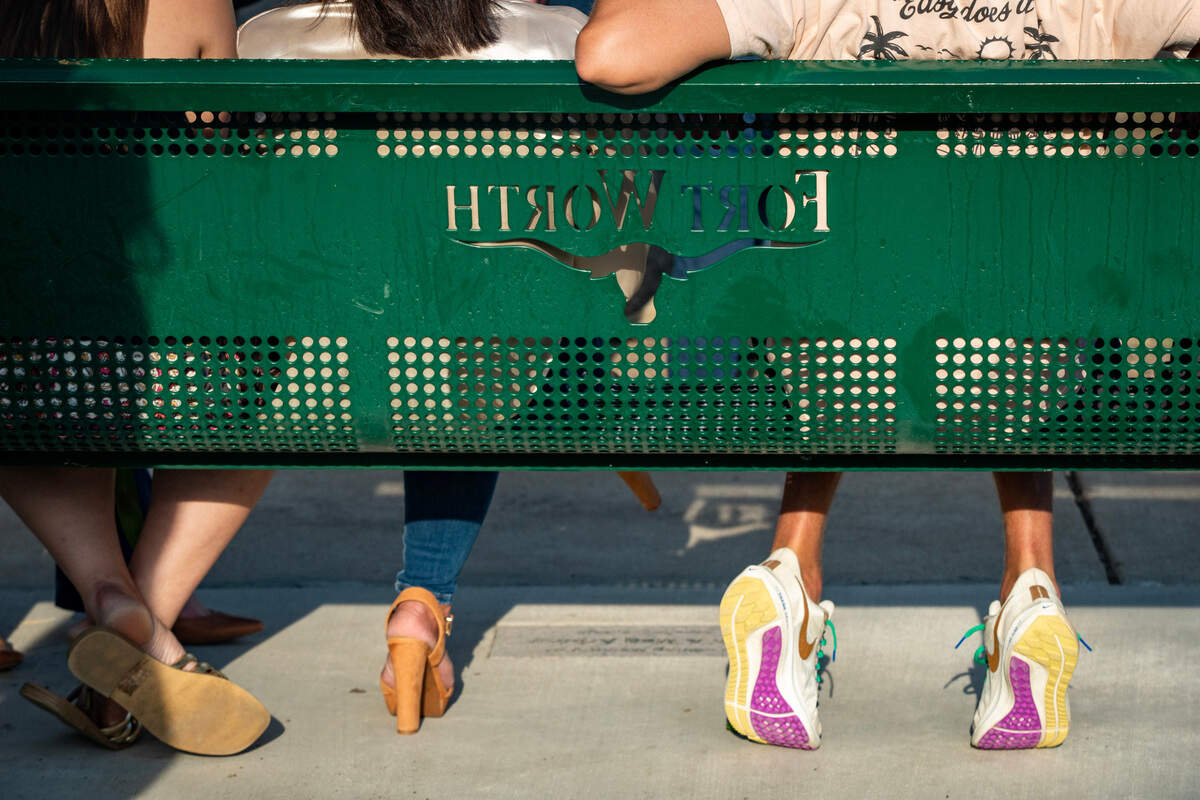 Family members and friends of Meg and Ben Arbour sit on a bench dedicated to them in the Summer Creek Ranch neighborhood of Fort Worth on Wednesday, May 3, 2023. The couple was killed in a car accident caused by two vehicles racing at night in November 2020.