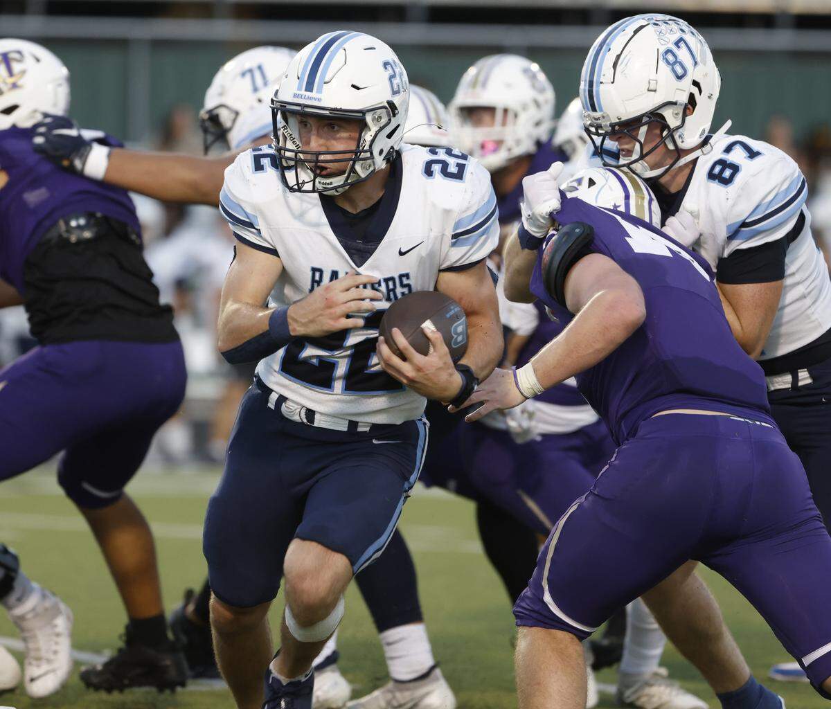 L.D. Bell running back Brendon Gleim (22) brings the ball through a crowd during the first half of a UIL football game between L.D. Bell and Timber Creek at Keller ISD Athletic Complex in Keller on Thursday, Sept. 11, 2025.