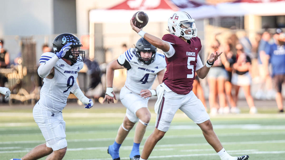 Lewisville quarterback  Tre Williams  makes a throw as Andrew Thompson (9) and Campbell Blair (4) give chase Thursday at Max Goldsmith Stadium in Lewisville. Special to the Star-Telegram / Tom Marvin