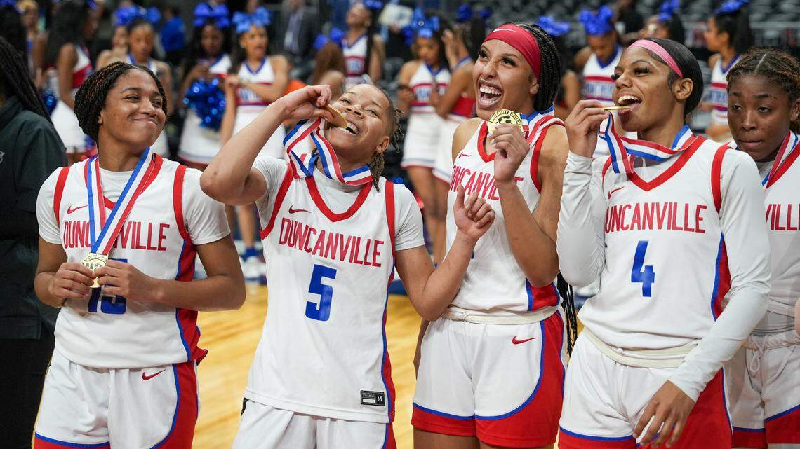 Duncanville players celebrate with their medals after a victory over South Grand Prairie in the Class 6A state championship game on Saturday, March 2, 2024 at the Alamodome in San Antonio, Texas. Duncanville defeated SGP 59-41.