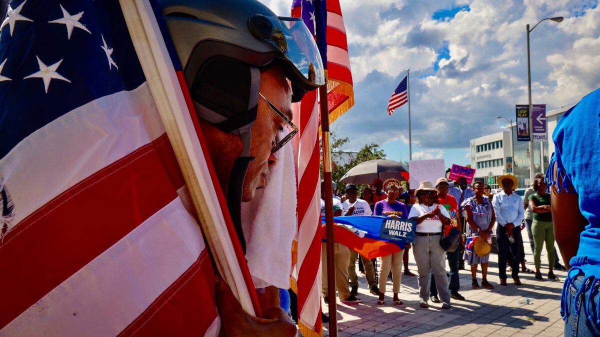 In North Miami, members of South Florida’s Haitian community take part in a rally hosted by the Miami-Dade Democratic Haitian Caucus to denounce attacks against Haitians by Donald Trump and JD Vance.