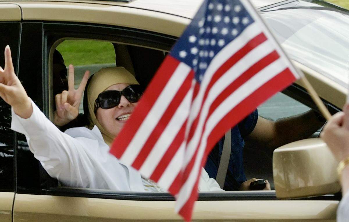 Parkgoers flash the “peace” sign and shout "God Bless America" to Americans Against Hate protesters at Six Flags Over Texas in Arlington, Texas, on Oct. 14, 2007. The group was protesting Muslim Family Day.