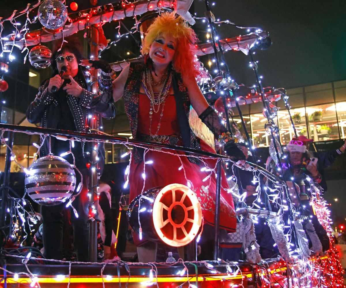 A Cyndi Lauper impersonator and others sang from the Studio 80 float during the 2023 GM Financial Parade of Lights.