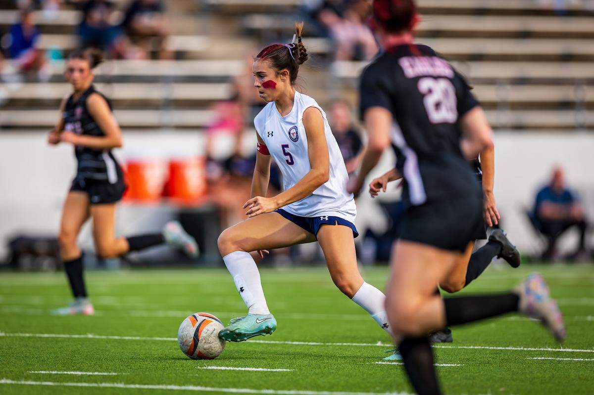 Grapevine’s Tatum Harig (5) dribbles through the Argyle defense in the Class 5A Division 2 Region 1 Final soccer match on Tuesday, March 31, 2026, at Northwest ISD Stadium in Justin, Texas.