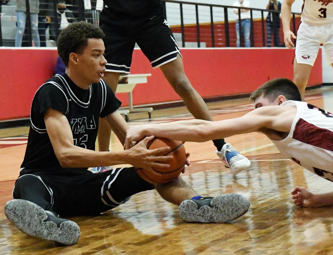 Young Men’s Learning Academy’s Kiyel Smith, left grabs the loos ball as Argyle’s Eli Valentino makes a grab for it during the third period of their 4A Region I Quarterfinal playoff game Saturday, February 27, 2021 at Colleyville Heritage High School in Colleyville, Texas. Argyle went on to win 49-40. Special/Bob Haynes