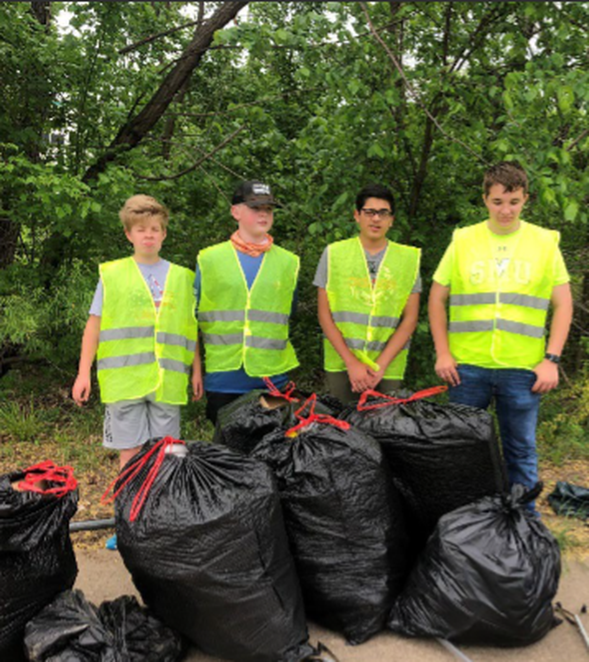 Daniel Thomas (second from right) has organized hundreds of cleanups at North Texas parks starting at age 11. The 17-year-old Colleyville senior has removed 45,000 pounds of plastic and other trash from local waterways.