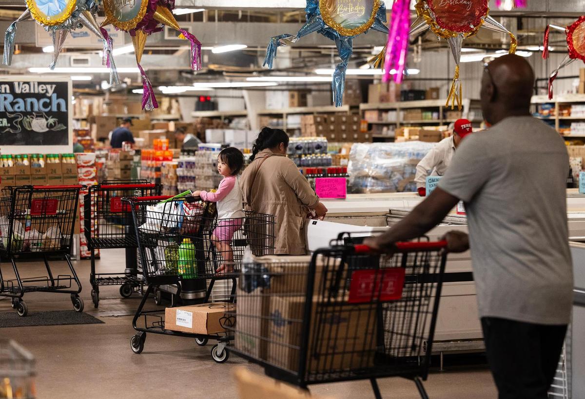 Customers shop at Town Talk Foods on Monday, April 21, 2025, in Fort Worth. The shop is considered a “salvage grocery” and can sell products at a steep discount.