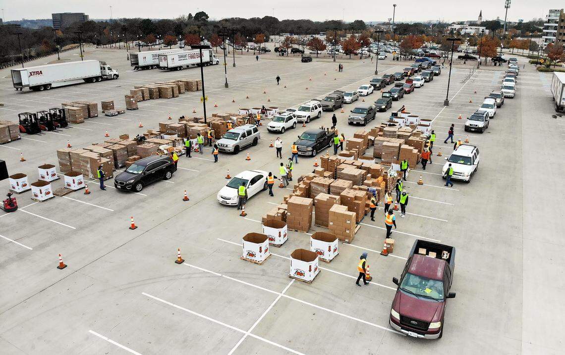 Dec. 15, 2020: Volunteers load 85 pounds of food per family into vehicles during a special holiday mega mobile distribution by the Tarrant Area Food Bank in partnership with the Goodfellow Fund in Fort Worth.