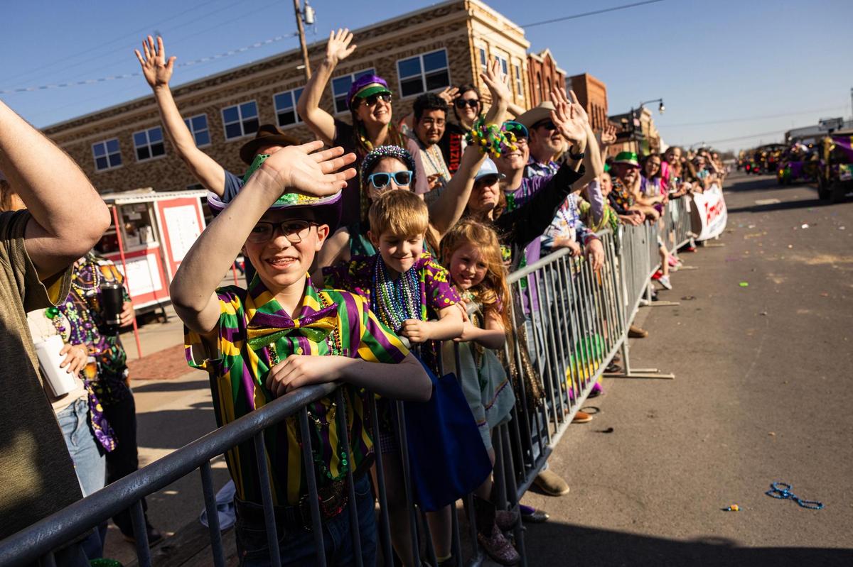 Luke Moody, 13, waves at the floats going by during the 15th Annual Mardi Gras Nocona Style on Clay Street in Nocona on Saturday, Mar. 1, 2025.
