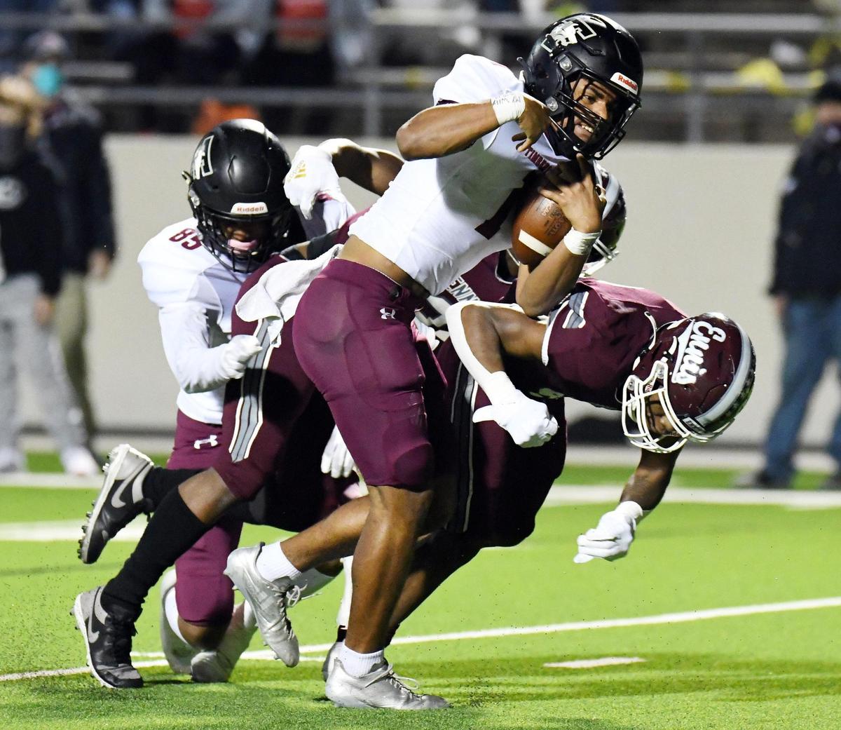 Mansfield Timberview quarterback Simeon Evans, center scrambles past Ennis’s Stephon Townsend 11 yards for the touchdown to take a 35 28 lead in the fourth quater of their Division 2 Region 2-5A Area Play-off football game Friday, December 18, 2020 at the Midlothian ISD Mult-Purpose Stadium in Midlothian, Texas. Special/Bob Haynes