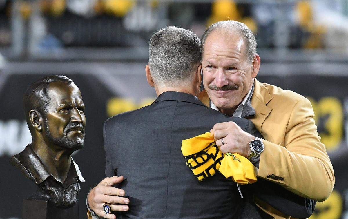 Oct 17, 2021; Pittsburgh, Pennsylvania, USA; Pittsburgh Steelers head coach Bill Cowher (right) embraces team President Art Rooney II during halftime against the Seattle Seahawks at Heinz Field. Cowher was recognized for his induction into the Pro Football Hall of Fame. Mandatory Credit: Philip G. Pavely-USA TODAY Sports