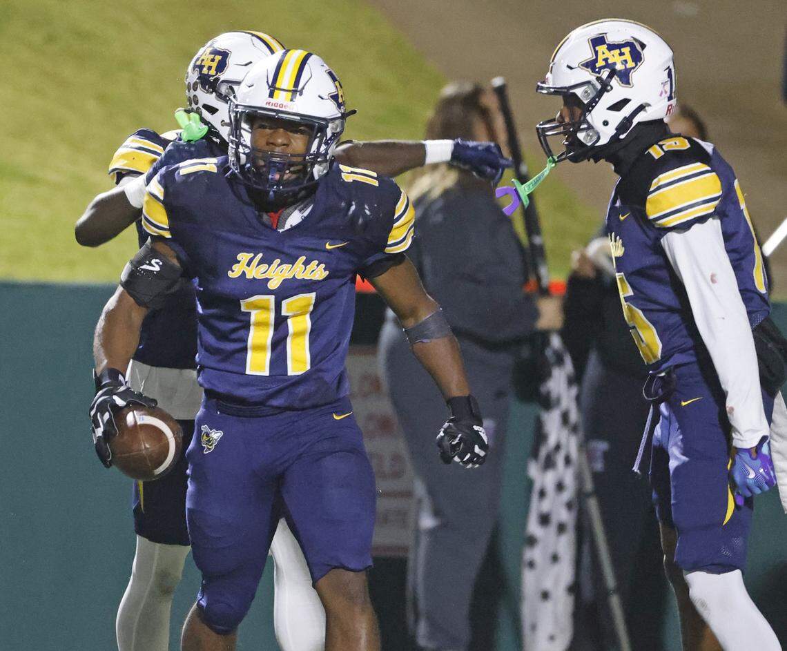 Fort Worth Arlington Heights outside linebacker Isaiah Schuman (11) comes out of the pile with his interception during the first half of a UIL Class 5A DI area-round football playoff game Thursday Nov. 20, 2025 at Shotwell Stadium in Abilene, Texas.