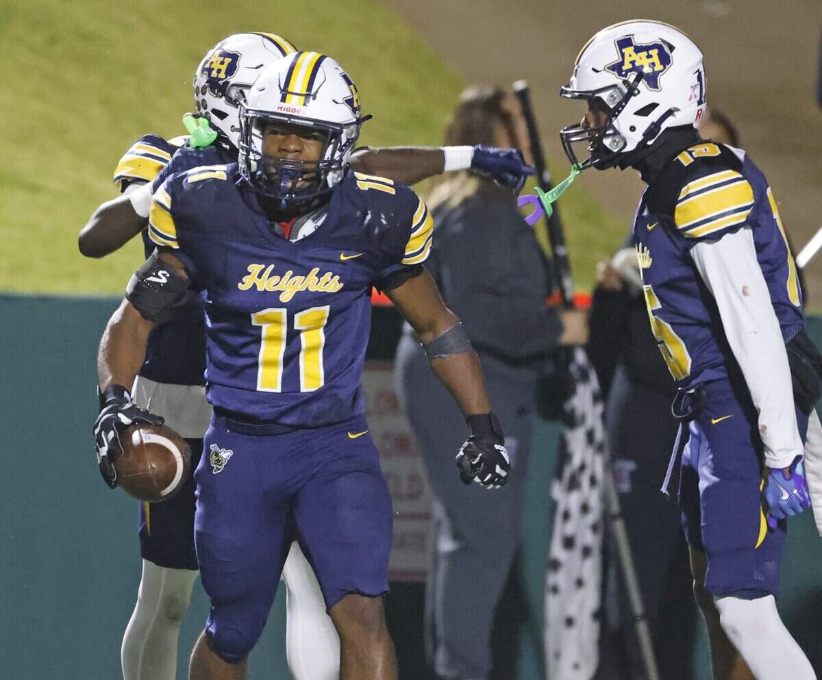 Fort Worth Arlington Heights outside linebacker Isaiah Schuman (11) comes out of the pile with his interception during the first half of a UIL Class 5A DI area-round football playoff game Thursday Nov. 20, 2025 at Shotwell Stadium in Abilene, Texas.