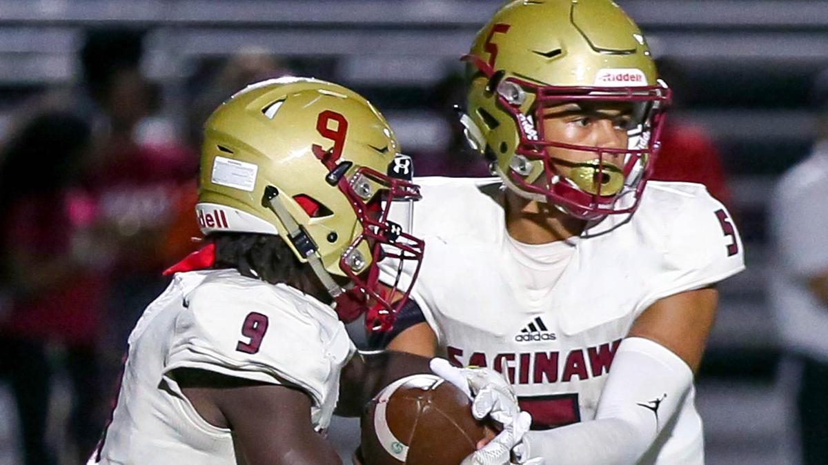 Saginaw quarterback Kameron Williams (5) hands the ball off to running back Michael Jones (9) against Crowley during the 2nd half, Friday night, September 27, 2019 played at Eagle Stadium in Crowley, TX.