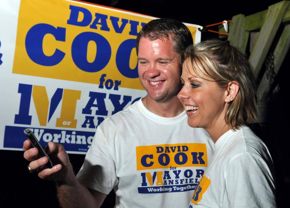May 10, 2008: Mansfield mayorial candidate David Cook and his wife Tonya Cook read a text message on his cell phone showing that he is ahead of his opponent Bryndan Wright in Satursday’s mayor election. His election party was held at Stevens Gardens & Grill in Mansfield.