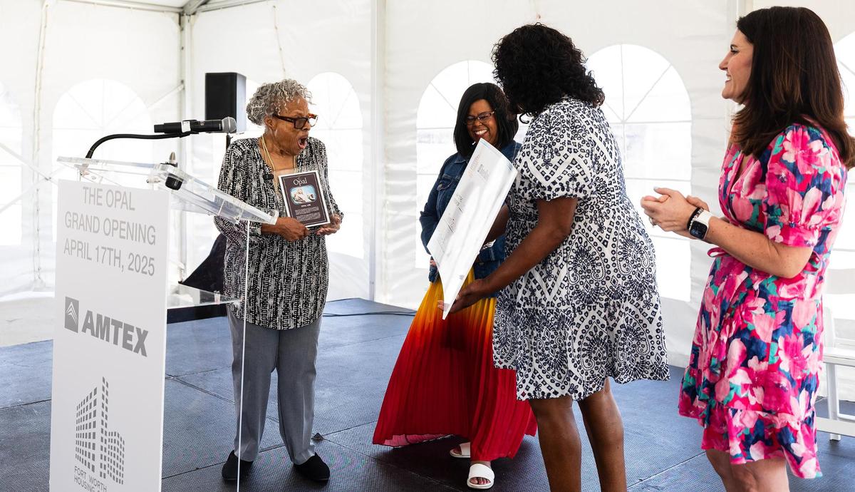 Opal Lee, left, reacts to a presentation check for a donation to the National Juneteenth Museum during the grand opening of The Opal, a mixed-income community, on Thursday, April 17, 2025. The affordable housing property was named in honor of Lee.